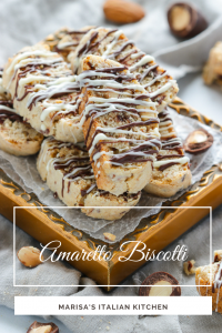 Tender and crumbly Amaretto Biscotti chock full of roasted almonds, chocolate covered almonds and drizzled with more chocolate.