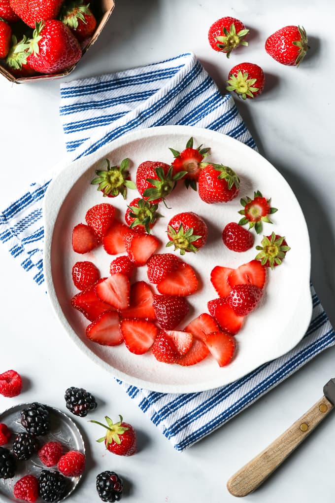 Chopped strawberries on a white plate.