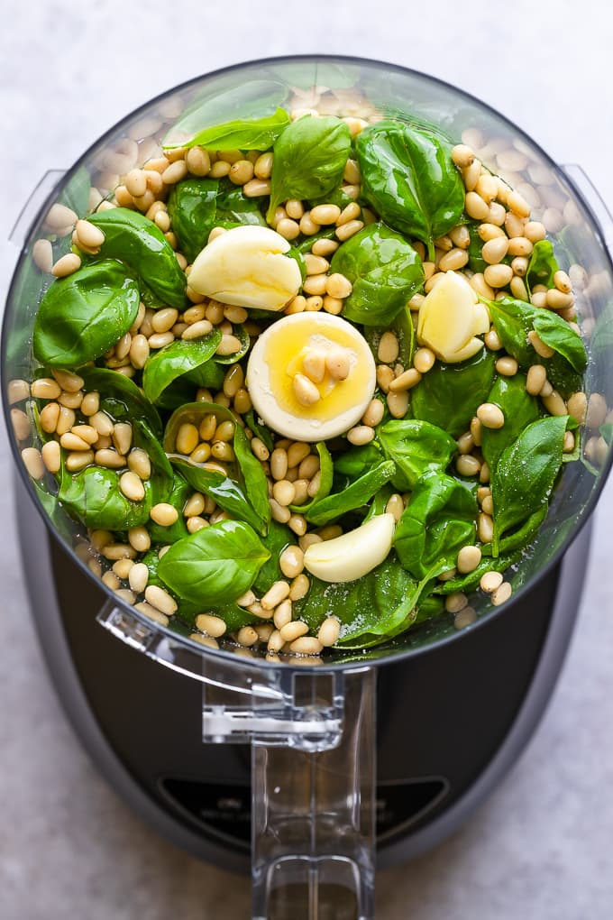 Basil leaves, pine nuts, garlic and salt in a food processor.