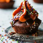 Chocolate dipped mini brownie bites with cream cheese frosting.