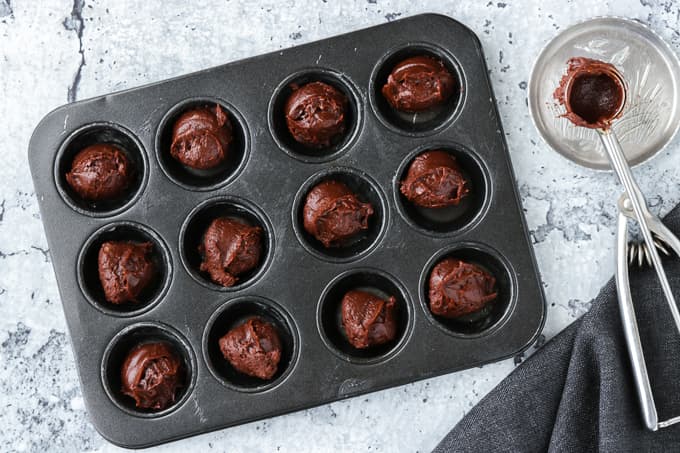 Mini baking tins filled with brownie batter.