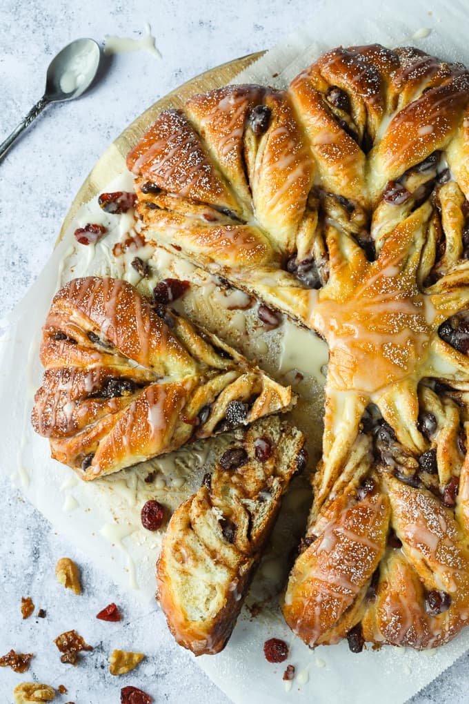Star bread with chocolate and cranberries with two slices cut off.