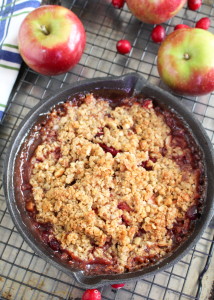 Apple and cranberry crisp in a cast iron skillet.