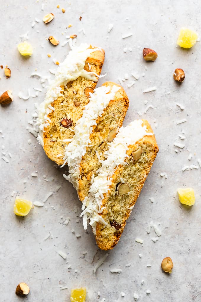 Three almond biscotti with pineapple, coconut and topped with melted white chocolate.