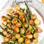 Freshly roasted asparagus and potatoes on a cutting board.