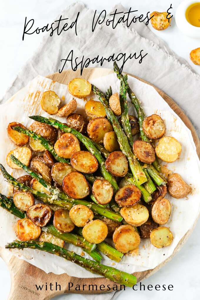 Freshly roasted asparagus and potatoes on a cutting board.