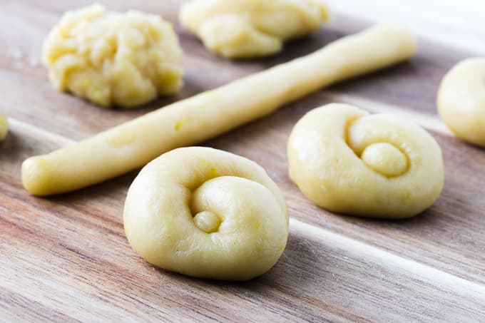 Rolled knot cookies on a wooden board.