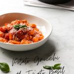 A bowlful of gnocchi with tomato sauce.