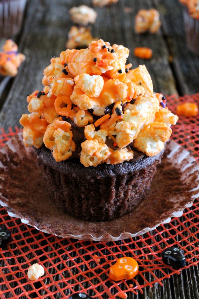 Orange chocolate popcorn on top of cupcakes.