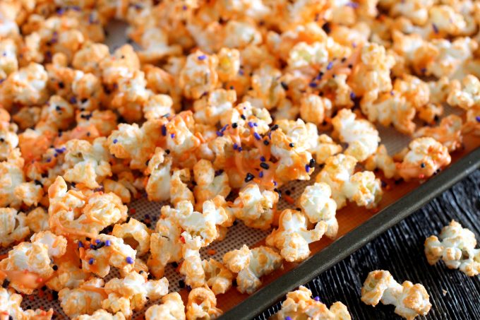 Orange chocolate popcorn on a baking sheet.