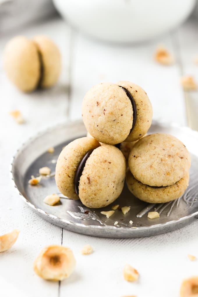 Italian baci di dama cookies on a silver tray.