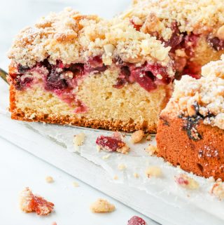 Serving a slice of cherry crumb cake