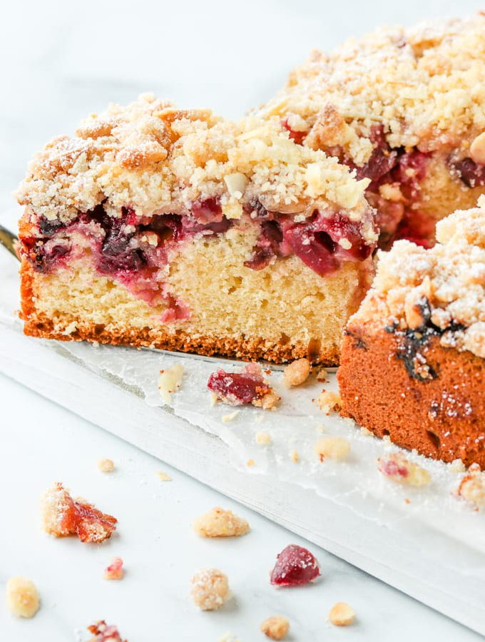 Serving a slice of cherry crumb cake