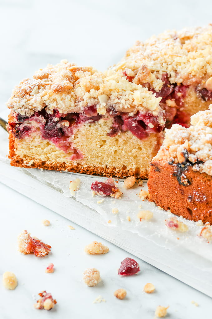 Serving a slice of cherry crumb cake