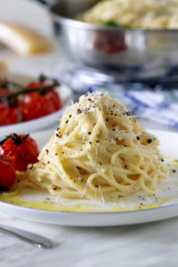Spaghetti with Roasted tomatoes on a white plate.