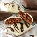 White and dark chocolate cookies on a silver rack