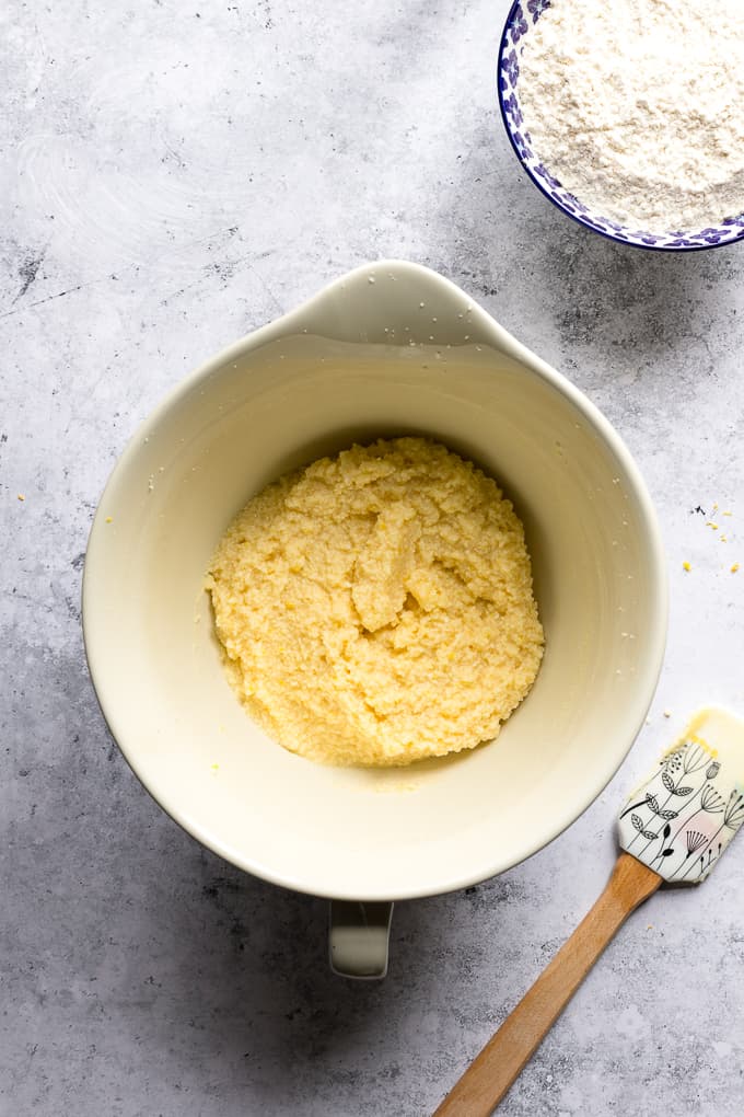 Mixed lemon cookie batter dough in a white mixing bowl.