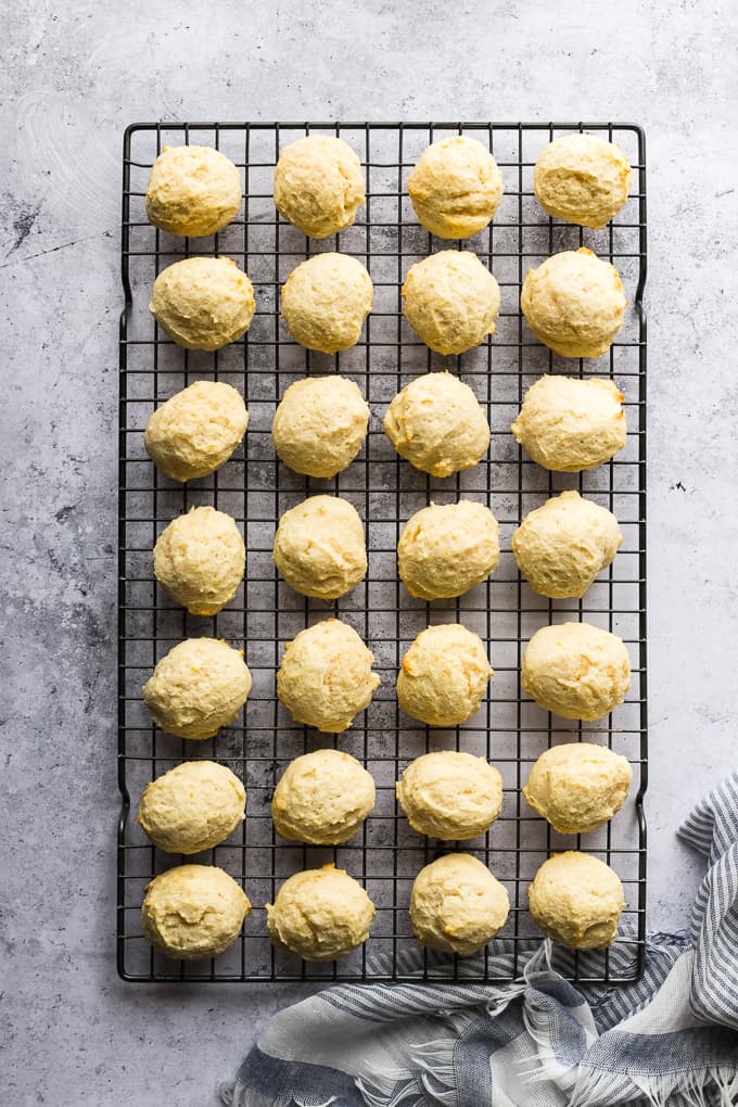 Italian lemon cookies set over a black cookie rack to cool off.