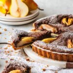 Chocolate and Pear Crostata with a slice cut off.