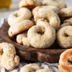 Italian wine cookies with anise on a wooden serving tray.