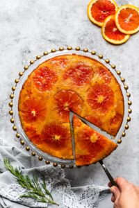 Upside-down orange marmalade cake with a slice cut off.