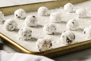 Cookies rolled in powdered sugar.