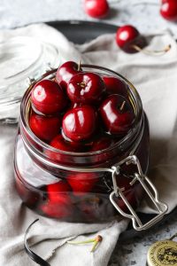 Cherries in a glass jar.