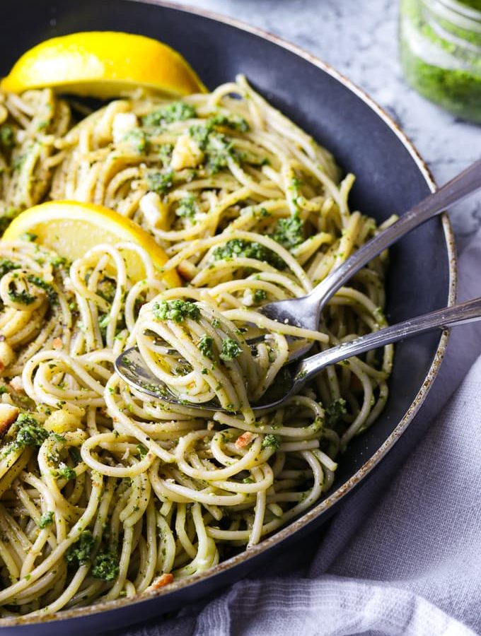 Spaghetti with walnut kale pesto in a skillet.
