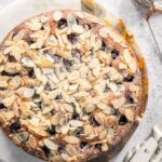 Almond topped Italian Grape cake on a marble board.