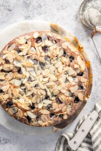 Almond topped Italian Grape cake on a marble board.