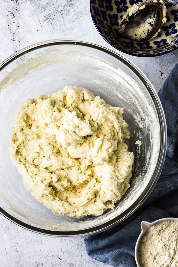 Water, yeast and flour in a large glass bowl.