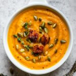 Roasted butternut squash soup garnished with pumpkin seeds.