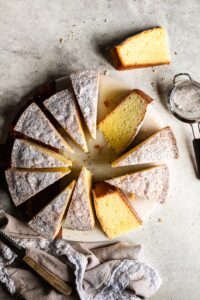 Sliced Torta Paradiso on a marble board.