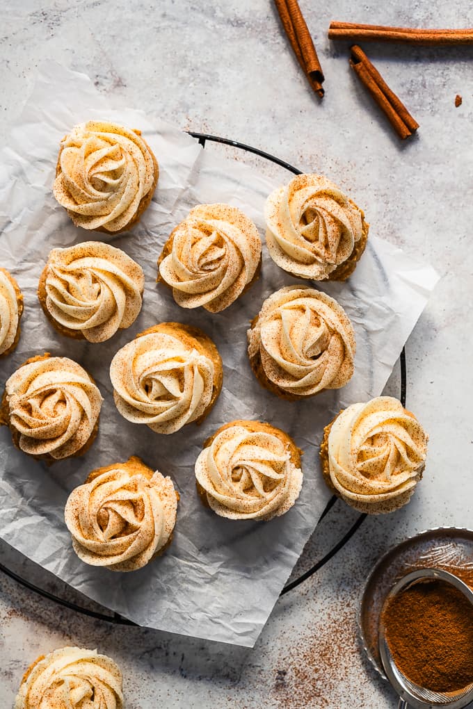 Ricotta cookies topped with cream cheese frosting and ground cinnamon.