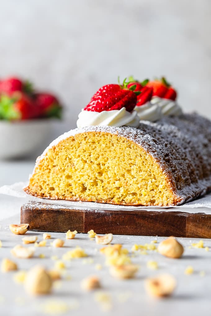 Italian Polenta Cake topped with strawberries and whipped cream.