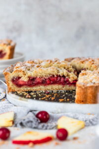 Apple Cranberry Crumble Cake with a slice cut off.